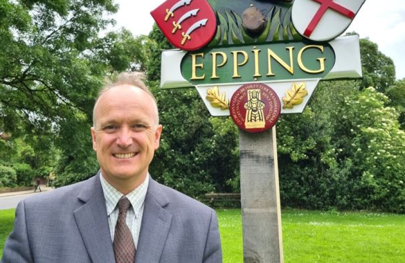 Dr Neil Hudson standing in front of Epping sign 